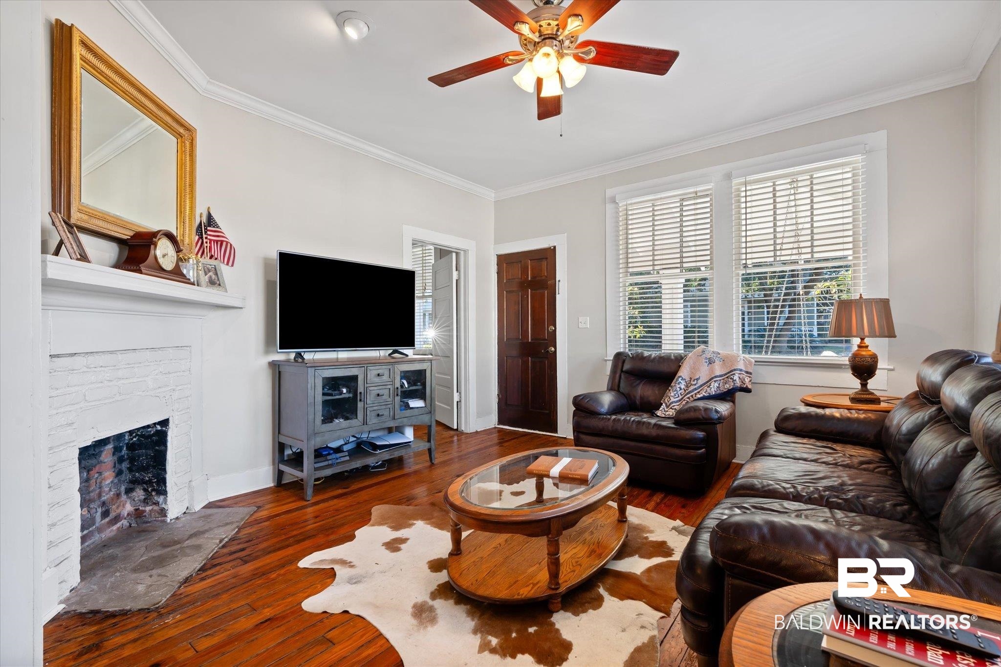 7 Rickarby Place Mobile, AL 36606 - Photo 4 of 20 Living room with dark hardwood / wood-style floors, ceiling fan, ornamental molding, and a fireplace