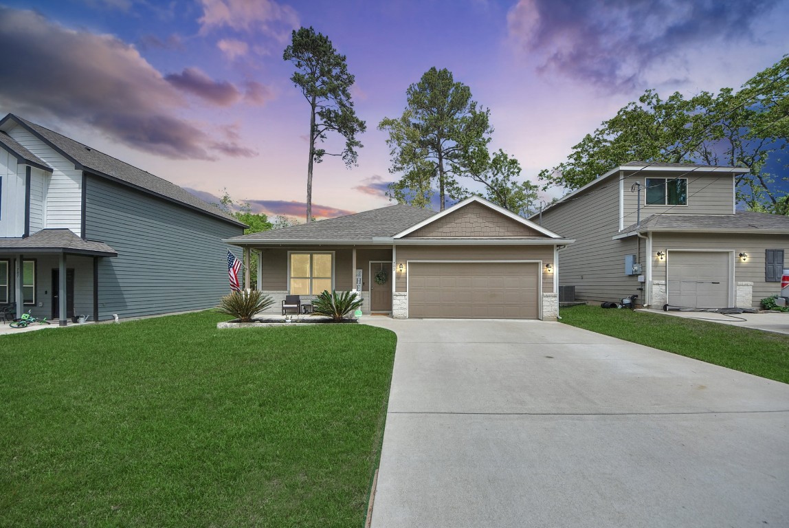 a front view of a house with a yard and garage