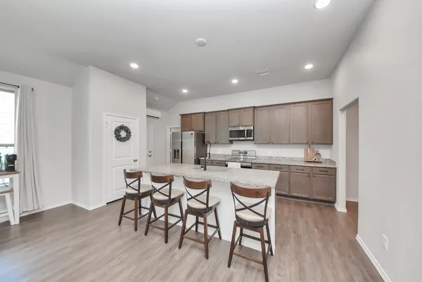 a large kitchen with a table and chairs in it