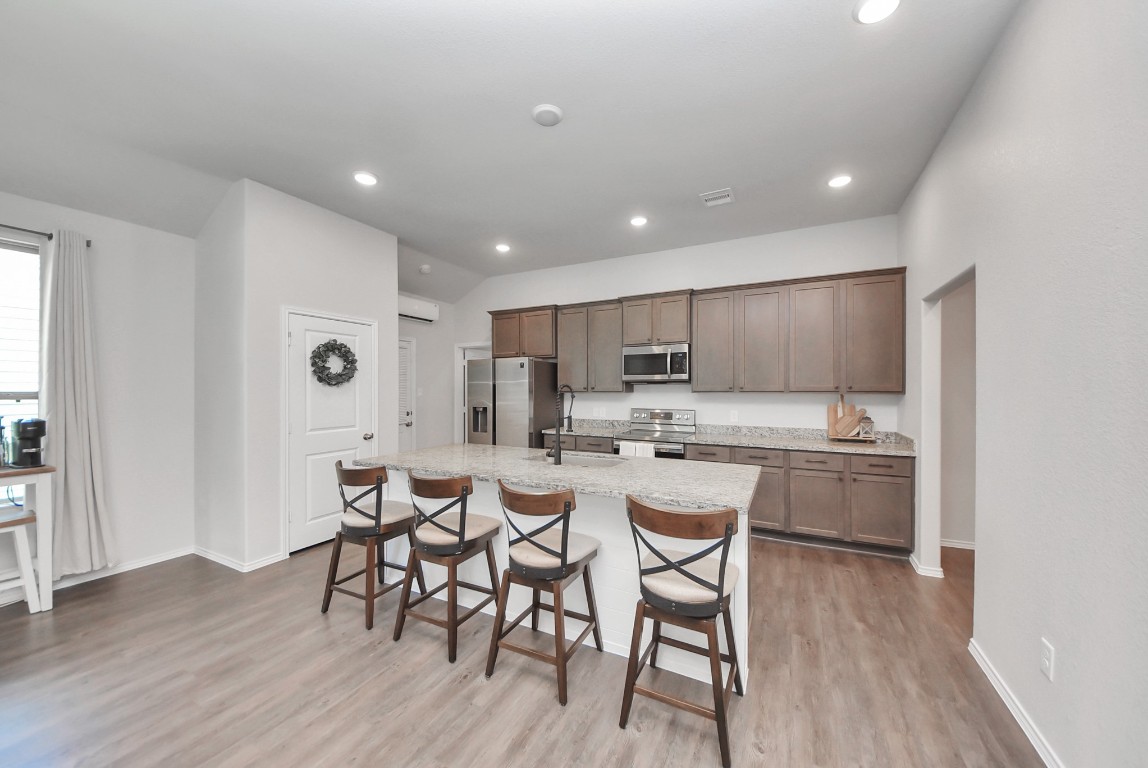 709 Little River Drive Montgomery, TX 77316 - Photo 14 of 40 a large kitchen with a table and chairs in it