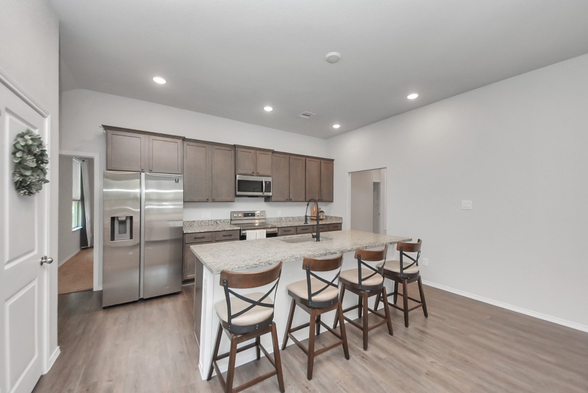 709 Little River Drive Montgomery, TX 77316 - Photo 15 of 40 a kitchen with stainless steel appliances a table and chairs