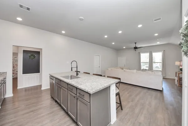 a spacious bathroom with a granite countertop sink and a large mirror