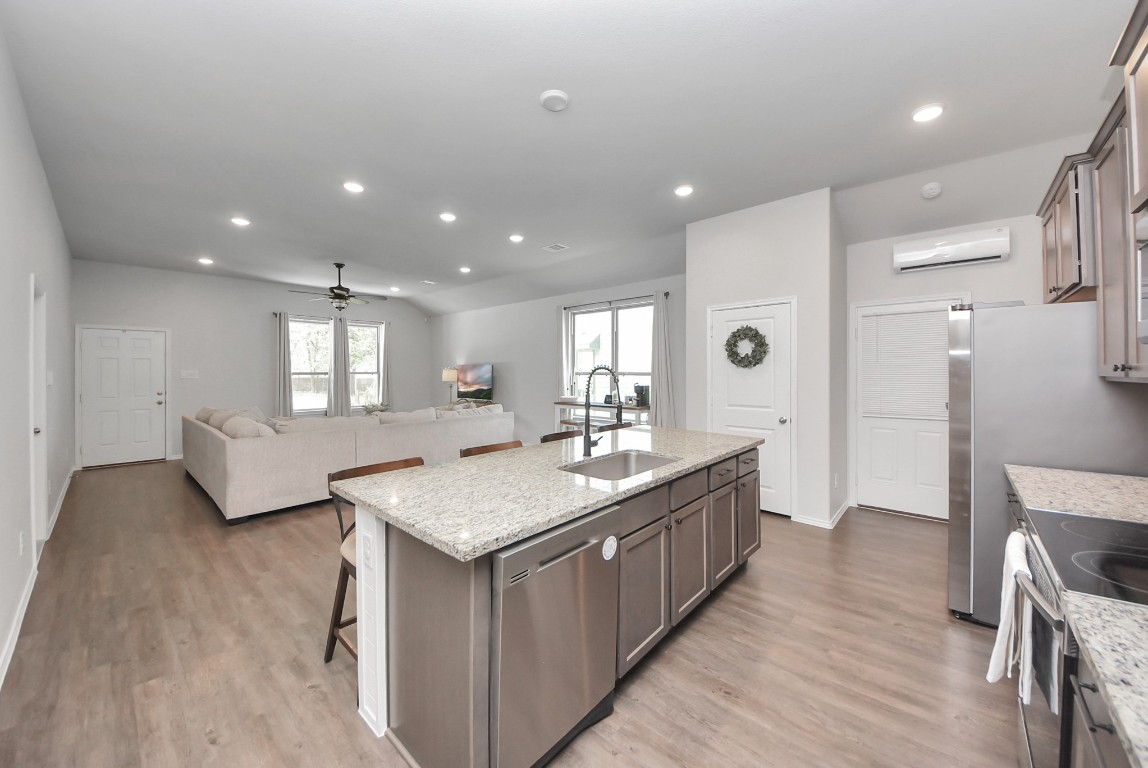 709 Little River Drive Montgomery, TX 77316 - Photo 18 of 40 a bathroom with a granite countertop sink a toilet a mirror and a tub