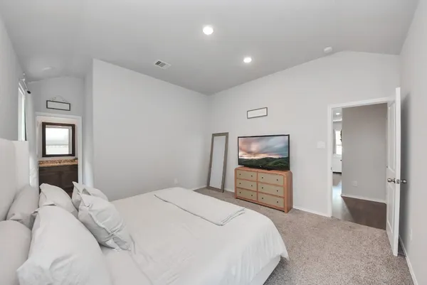 a bedroom with a bed and a view of bathroom
