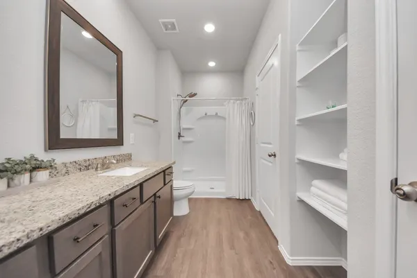 a bathroom with a double vanity sink and mirror with shower