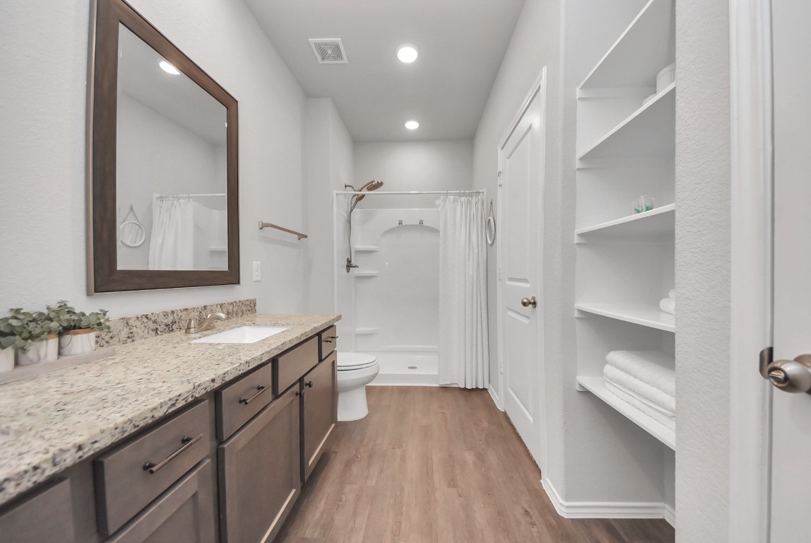 709 Little River Drive Montgomery, TX 77316 - Photo 25 of 40 a bathroom with a double vanity sink and mirror with shower
