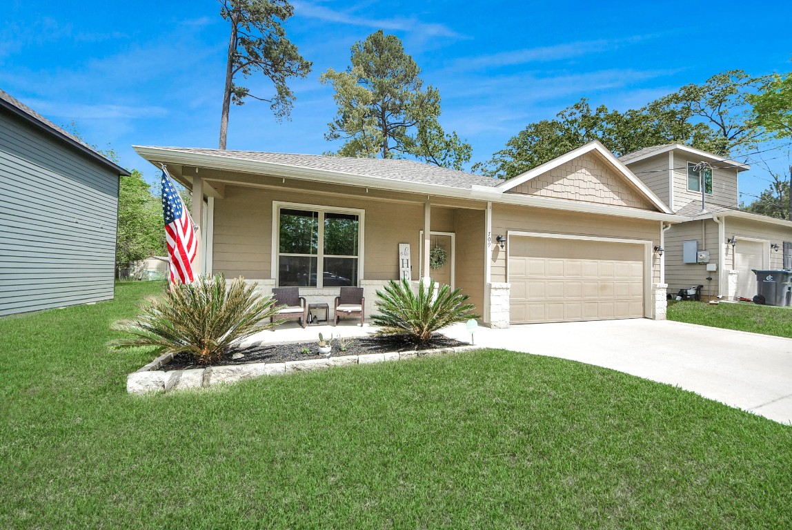 709 Little River Drive Montgomery, TX 77316 - Photo 3 of 40 a view of a house with a small yard and a large tree