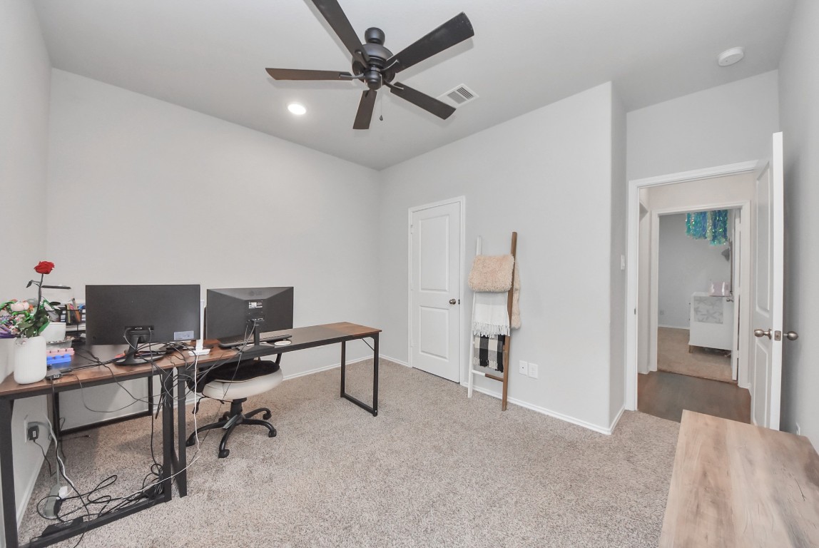 709 Little River Drive Montgomery, TX 77316 - Photo 31 of 40 a view of a workspace with furniture and a ceiling fan
