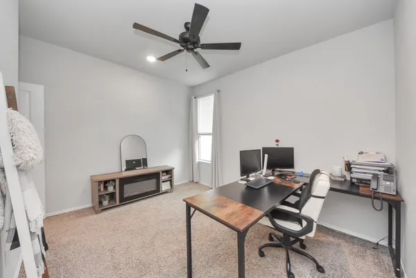 a workspace with a flat screen tv and a couch