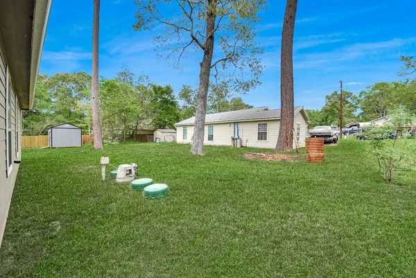 a view of a house with backyard sitting area and garden