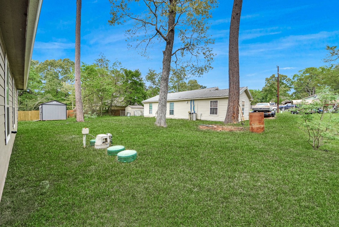 709 Little River Drive Montgomery, TX 77316 - Photo 34 of 40 a view of a house with backyard sitting area and garden