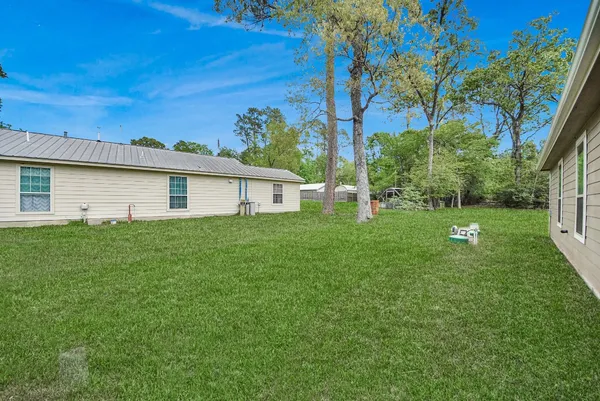 a view of an house with backyard space and garden