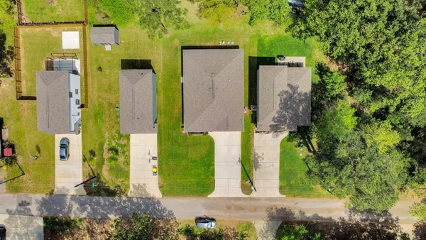 an aerial view of a house with a yard