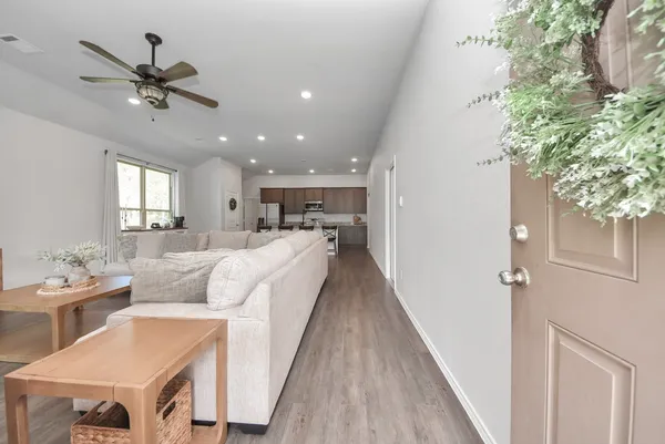 a living room with furniture and a potted plant