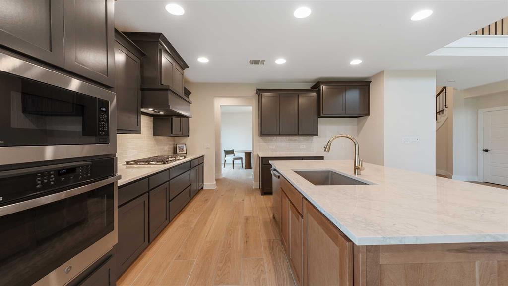 854 Stoney Bridge Way Lavon, TX 75166 - Photo 6 of 36 a kitchen with stainless steel appliances granite countertop a sink and a microwave