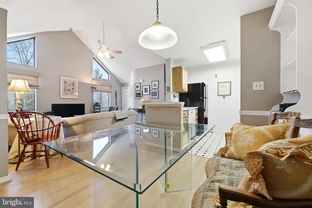 a living room with furniture and a dining table