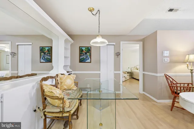 a living room with dining table and a wooden floor