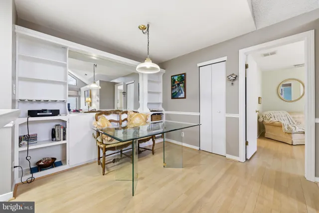 a living room with kitchen island furniture and a chandelier