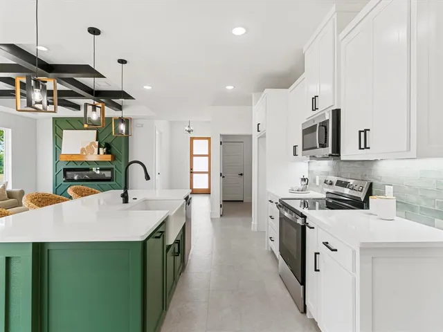 a kitchen with a sink stove and cabinets