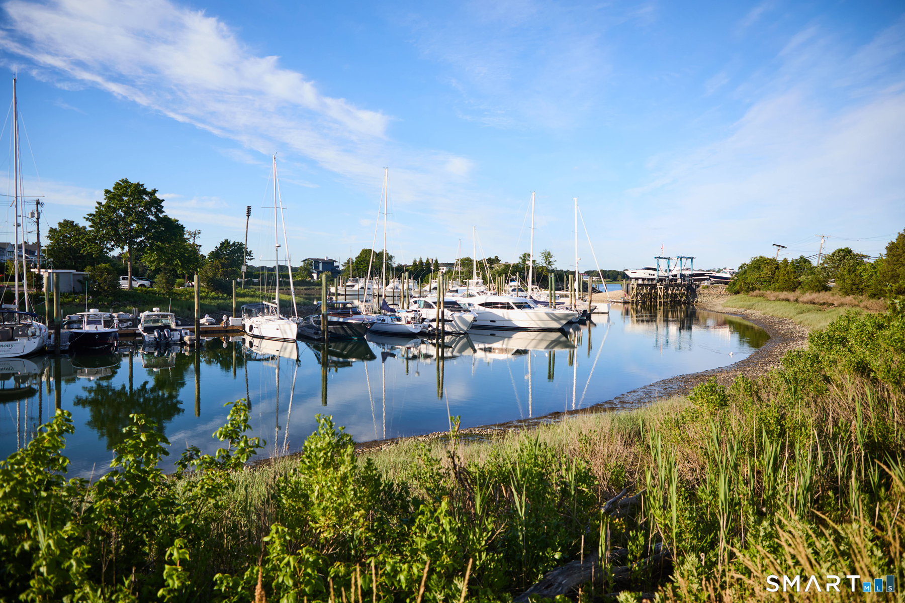 16 Harbor Road Westport, CT 06880 - Photo 30 of 36 a view of a ocean with boats and trees in the background