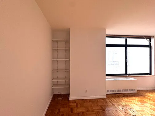 a view of kitchen with refrigerator and wooden floor
