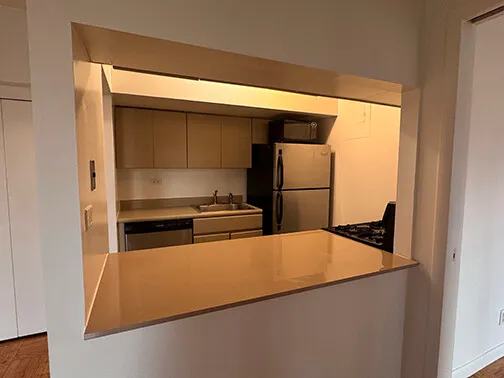 a kitchen with stainless steel appliances granite countertop a refrigerator and a stove