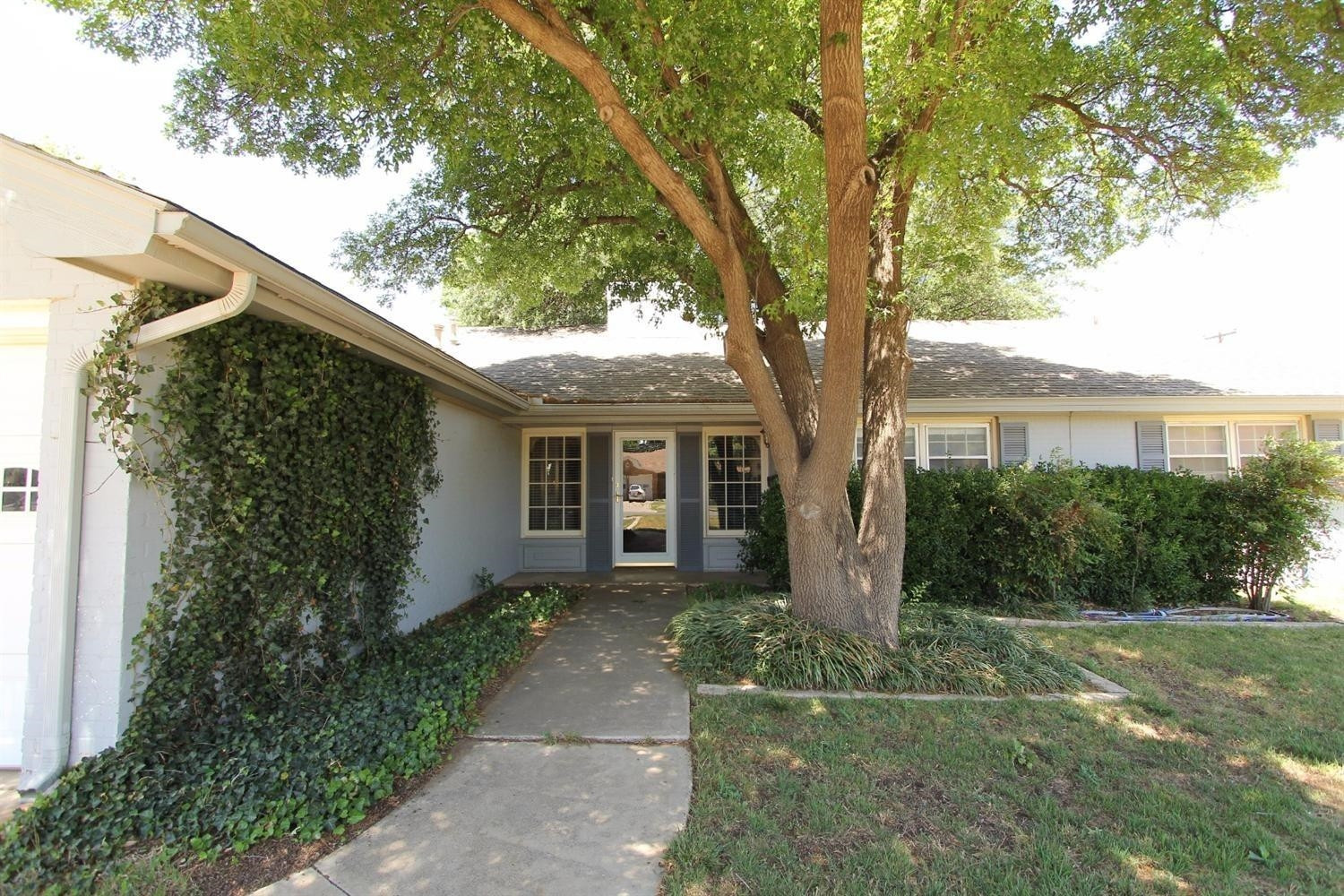 3412 60th Street Lubbock, TX 79413 - Photo 2 of 10 a front view of a house with garden
