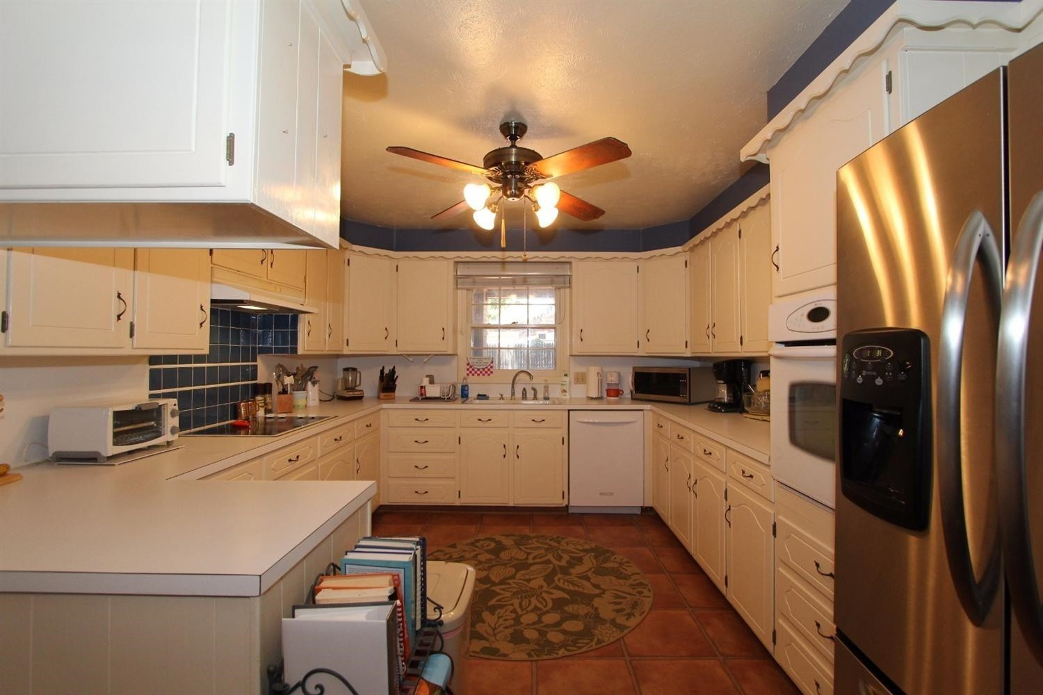 3412 60th Street Lubbock, TX 79413 - Photo 6 of 10 a kitchen with a sink cabinets and window