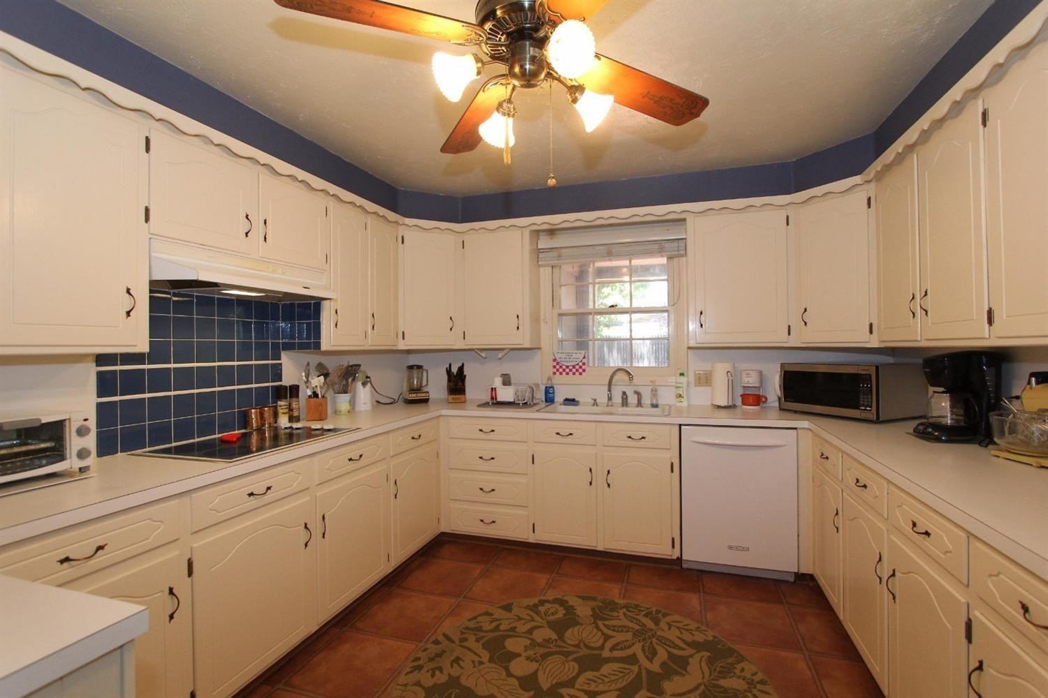 3412 60th Street Lubbock, TX 79413 - Photo 7 of 10 a kitchen with cabinets appliances a sink and a window