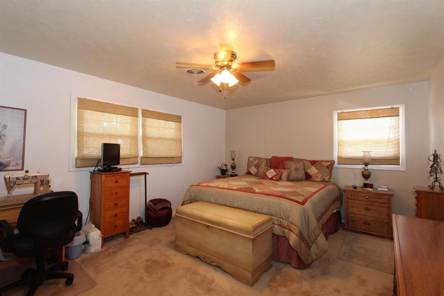 3412 60th Street Lubbock, TX 79413 - Photo 10 of 10 a bedroom with a bed and a chandelier
