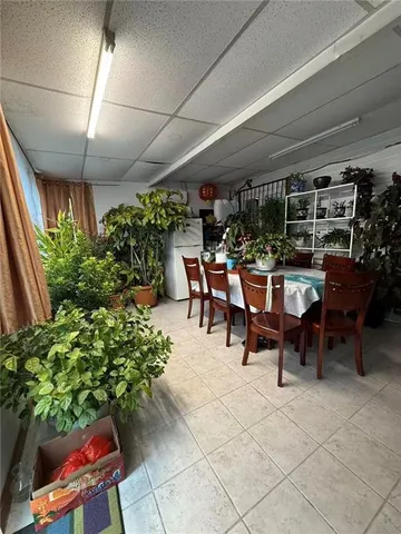 a spacious bedroom with a bed and wooden floor