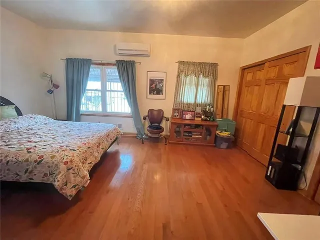 a bedroom with a bed and a tv