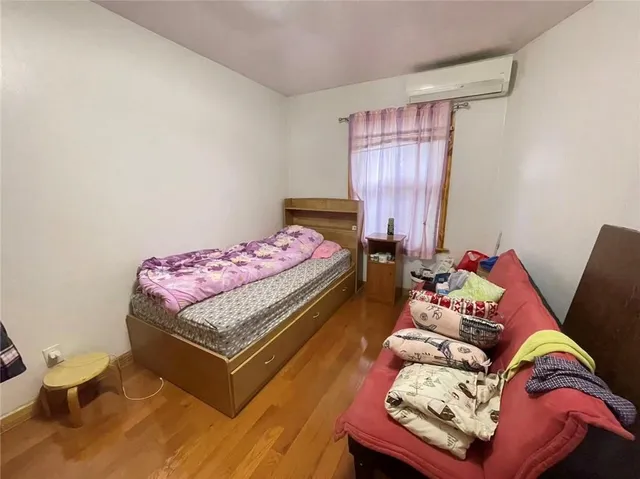 a bathroom with a granite countertop toilet sink washing machine and mirror