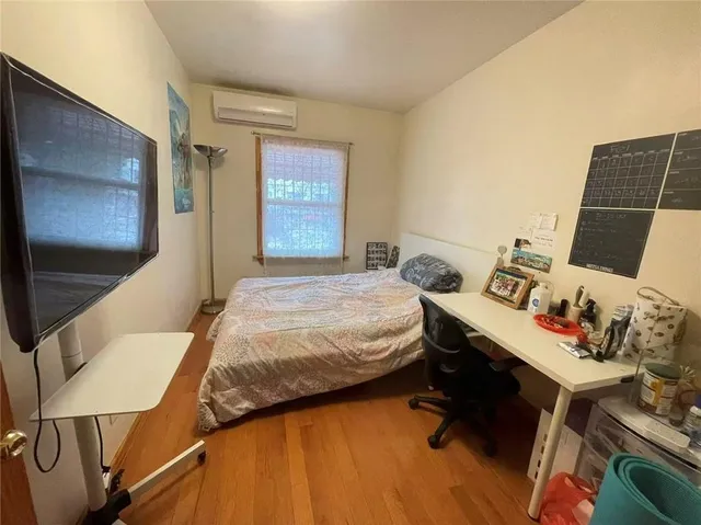 a bedroom with bed and window