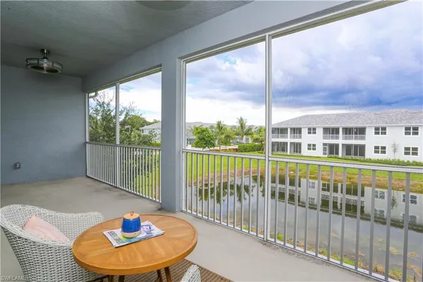 a view of a balcony that has two chairs and a table