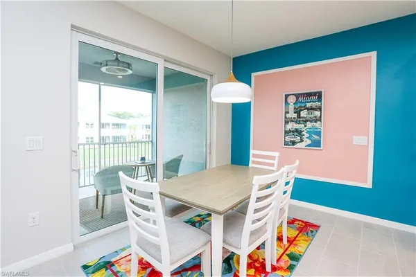 a view of a dining room with furniture and a window