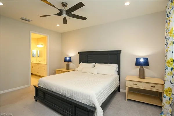 a bedroom with a bed and a lamp