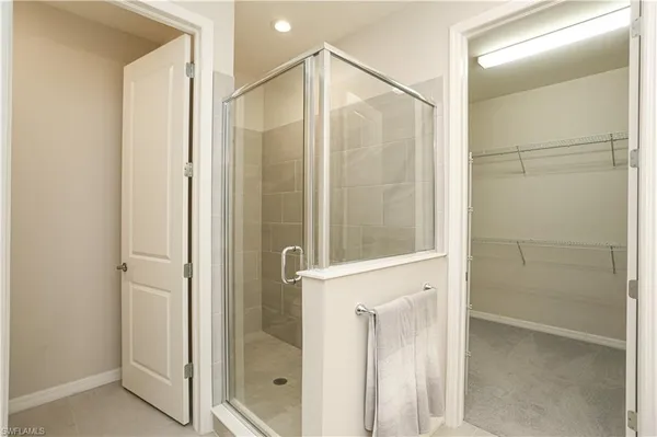 a bathroom with a glass shower door