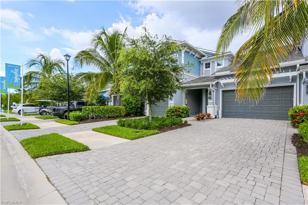 a front view of house with yard and green space