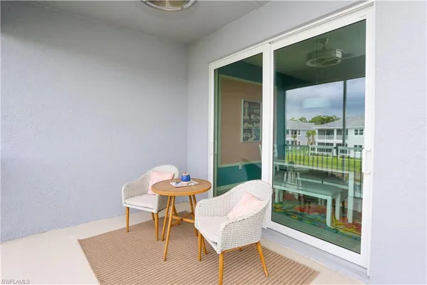 a view of a chair and table in a balcony