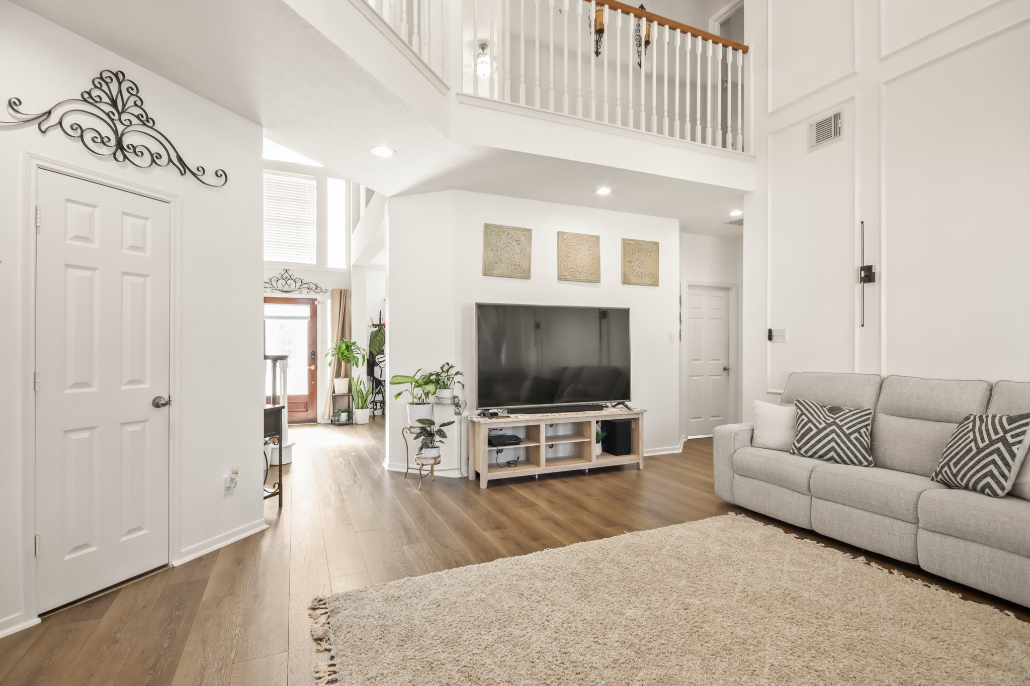20514 Cannaberry Way Spring, TX 77388 - Photo 12 of 42 Spacious living area with high ceilings, abundant lighting, and seamless flow into surrounding living spaces for easy entertaining.