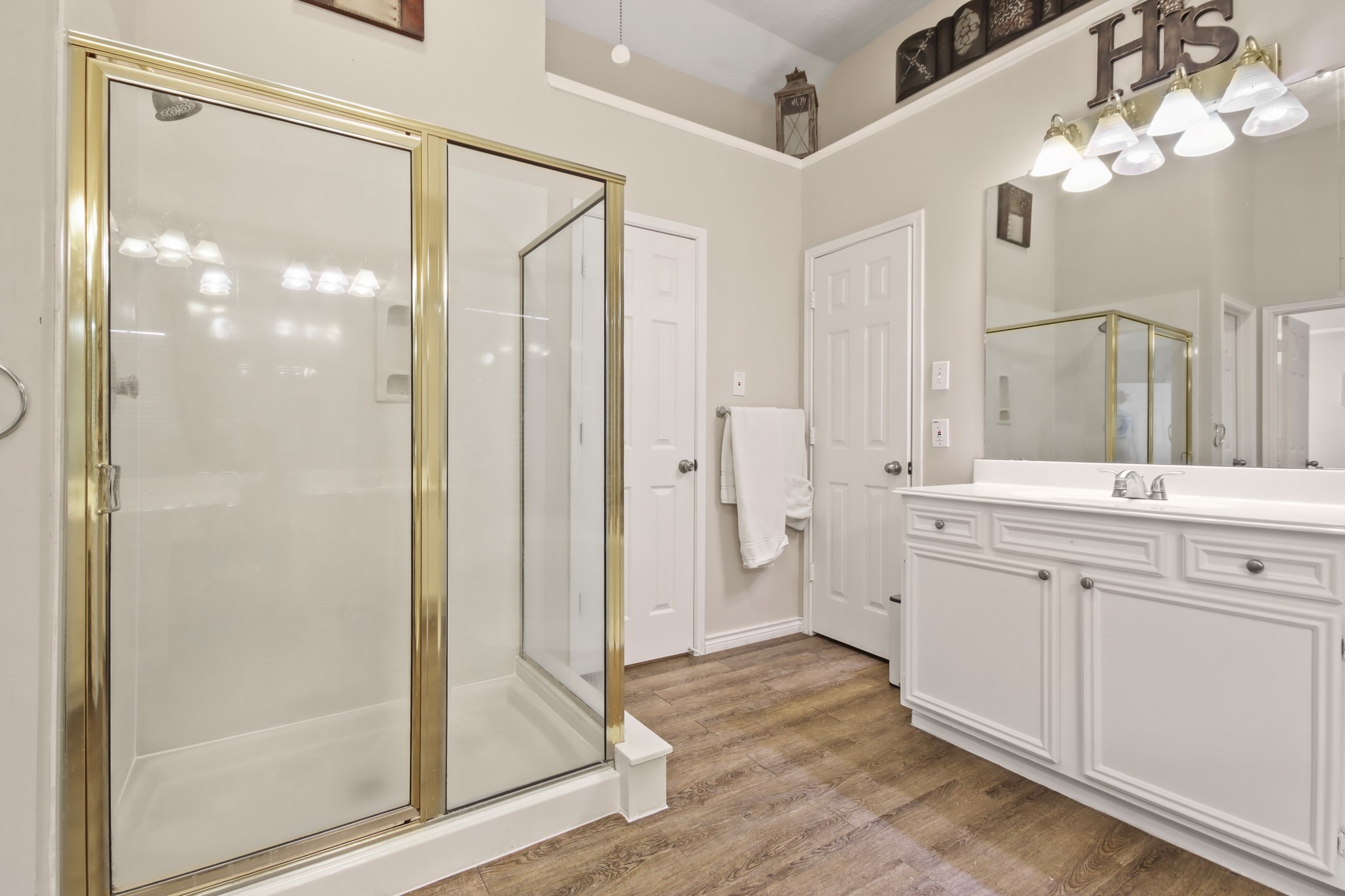 20514 Cannaberry Way Spring, TX 77388 - Photo 21 of 42 Luxurious en-suite showcasing an expansive vanity, glass-enclosed shower, and beautiful natural light. Designed for both functionality and relaxation.