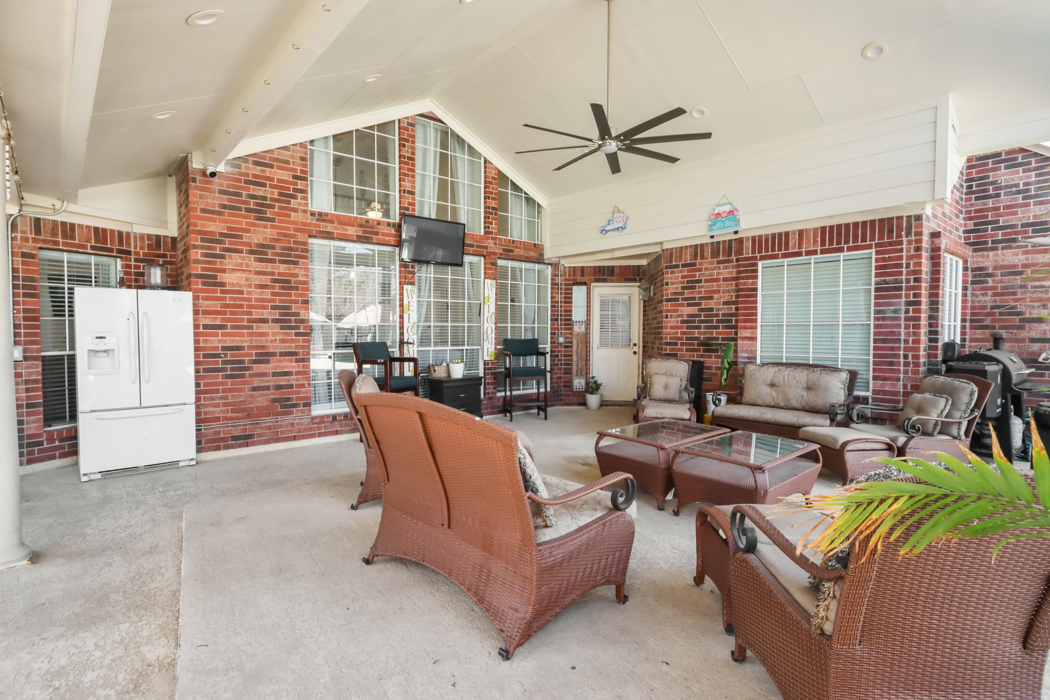 20514 Cannaberry Way Spring, TX 77388 - Photo 33 of 42 Spacious covered patio designed for year-round enjoyment, complete with ceiling fan, ample seating space, and seamless indoor-outdoor living perfect for entertaining guests.