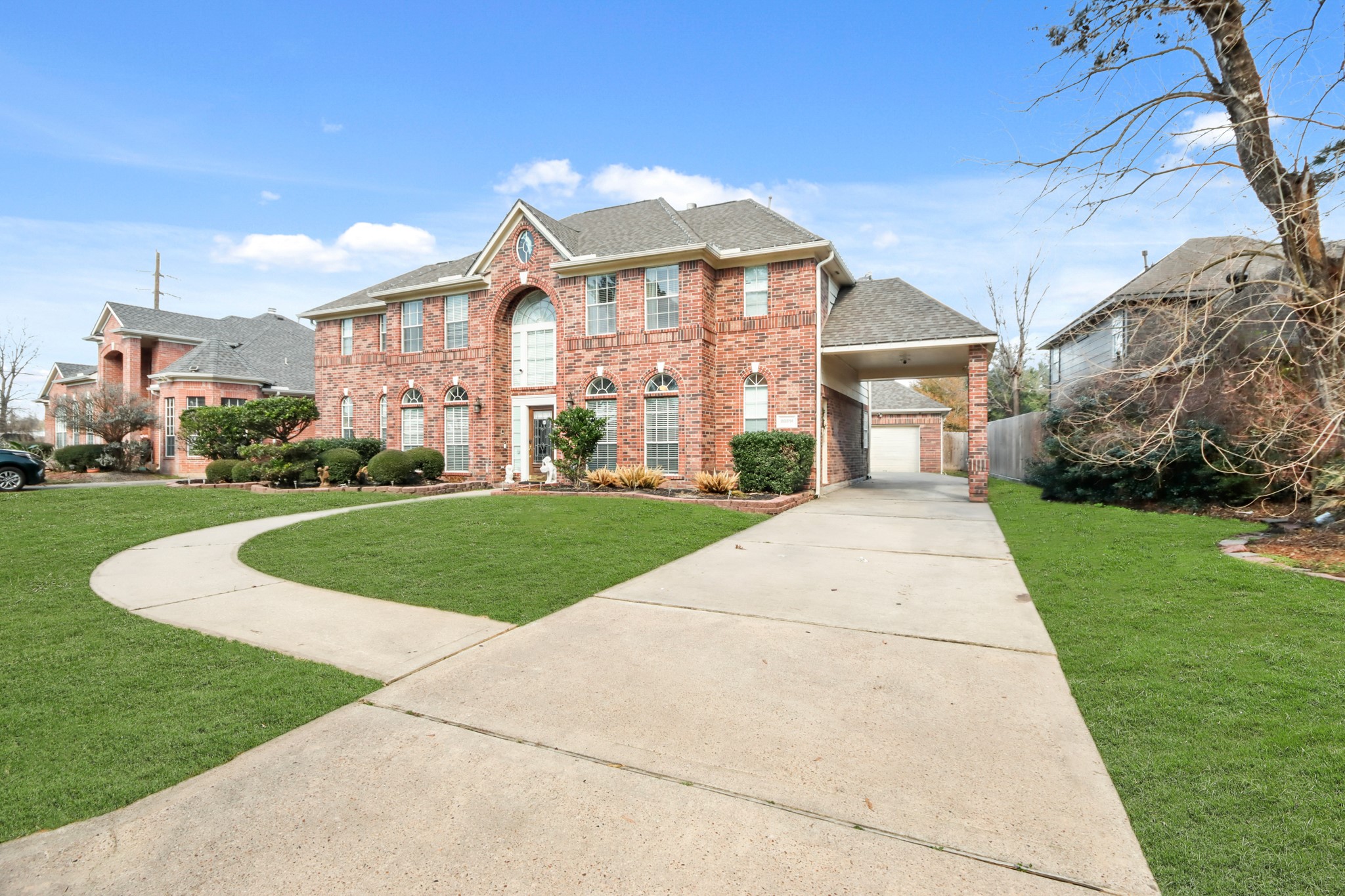 20514 Cannaberry Way Spring, TX 77388 - Photo 40 of 42 Welcoming exterior view showcasing the long driveway, spacious garage, and attractive landscaping that enhances both convenience and curb appeal.