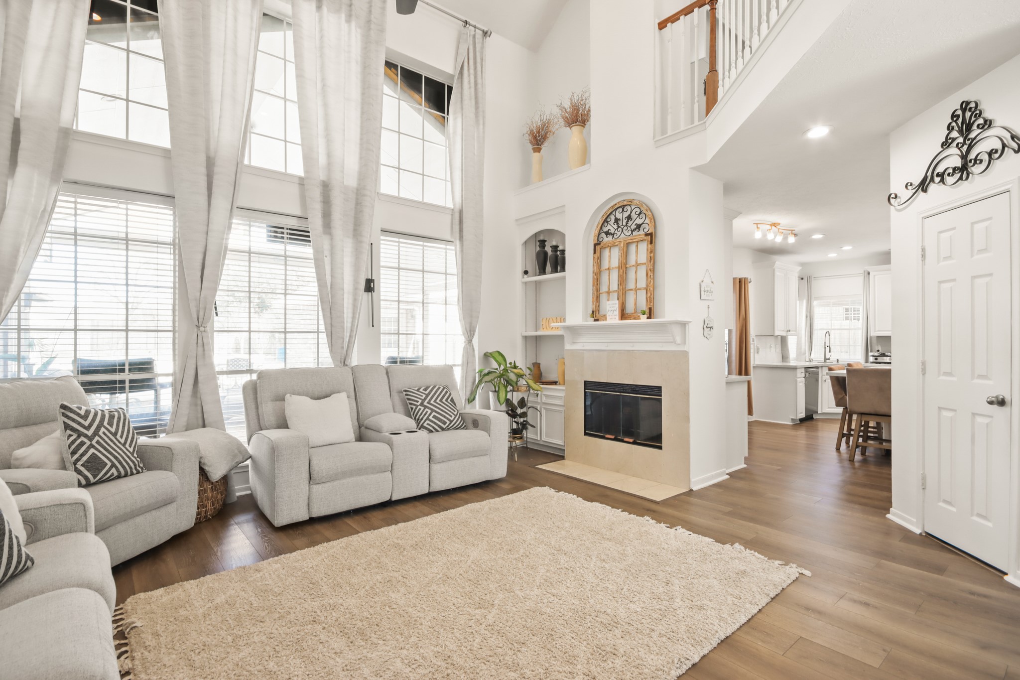 20514 Cannaberry Way Spring, TX 77388 - Photo 10 of 42 Elegant style featuring a beautiful fireplace, oversized windows, and spacious seating area perfect for relaxing or entertaining.