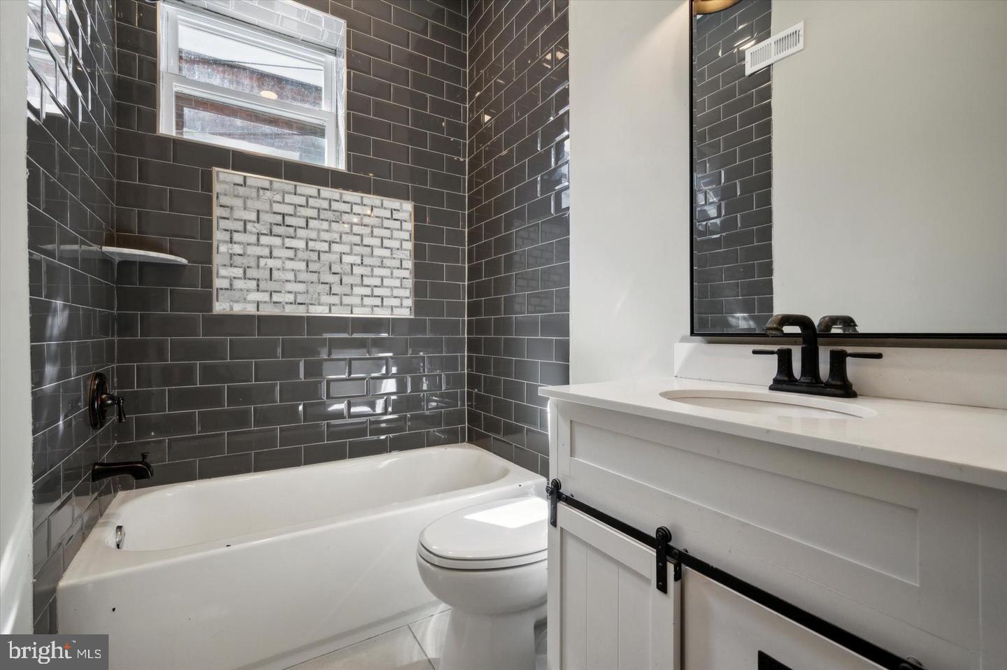 2021 North 33rd Street, Unit 1 Philadelphia, PA 19121 - Photo 12 of 21 a bathroom with a sink a toilet and bathtub