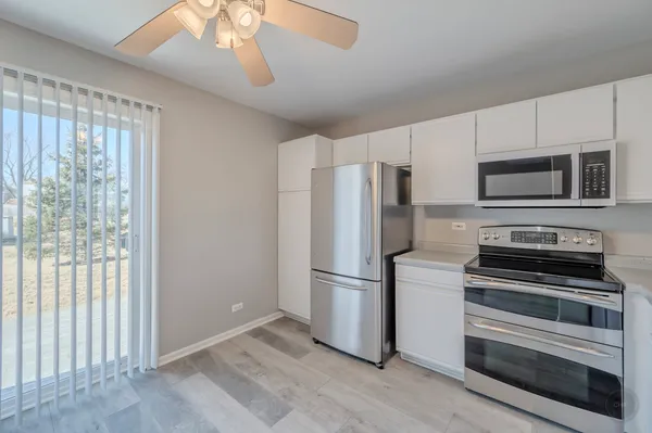a kitchen with a refrigerator stove and microwave