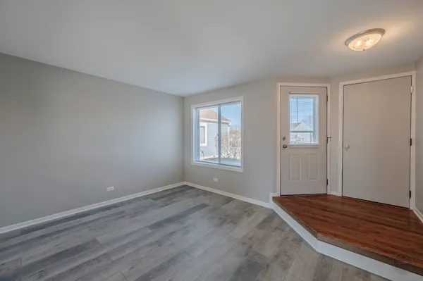 a view of room with window and wooden floor