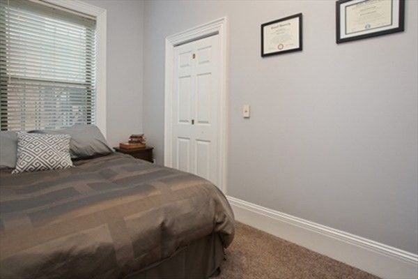 a bedroom with a bed and wall painting