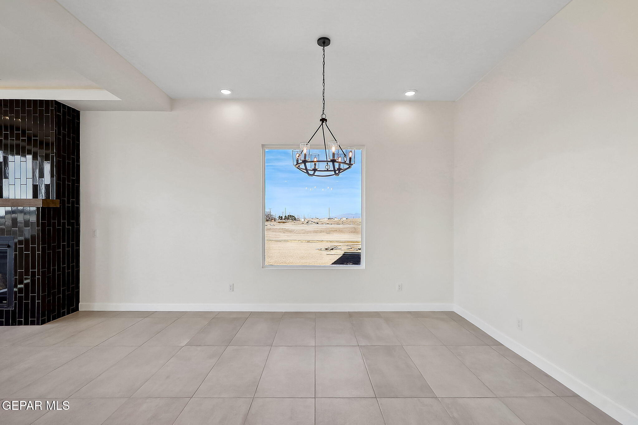 5997 Ruidoso Downs Street El Paso, TX 79932 - Photo 14 of 42 a view of a room with a chandelier fan and kitchen view
